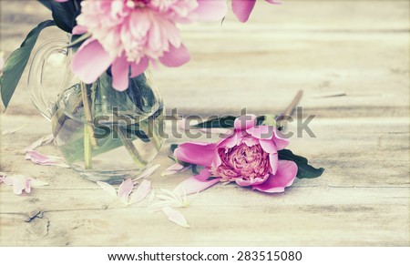 Pink roses in vase on wooden floor and bokeh background - retro styled photo
