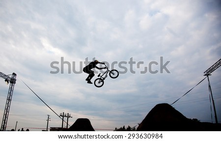 Silhouette of a man doing a jump with a bmx bike