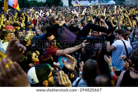 BONTIDA, ROMANIA - JUNE 27, 2015:Crowd surfing of Barry Ashworth from Dub Pistols at Electric Castle Festivall, one of the biggest music festivals in Romania
