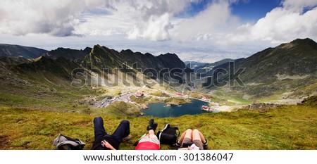 Friends relaxing high above Balea lake, Fagaras mountains