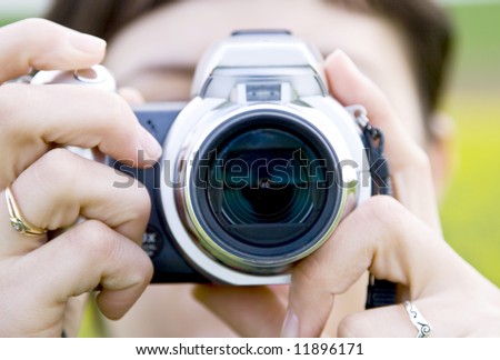 Woman shooting with point and shoot camera