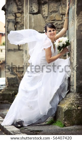 Beautiful bride posing among old church walls