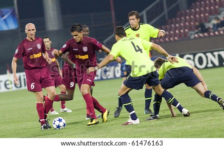 CLUJ-NAPOCA, ROMANIA - SEPTEMBER 15: Muresan and Bastos (in red) in action at a Champions League soccer game CFR Cluj vs. FC Basel, September 15, 2010 in Cluj-Napoca, Romania