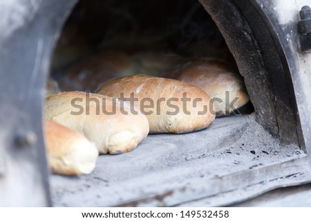 Traditional baking bread in a wood oven
