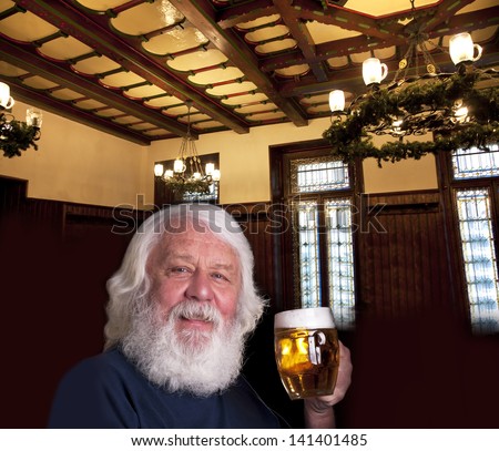 Beer - older bearded man drinking a beer in the pub