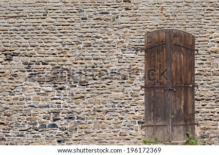 Wall with a door- old historic stone wall, Gothic architecture