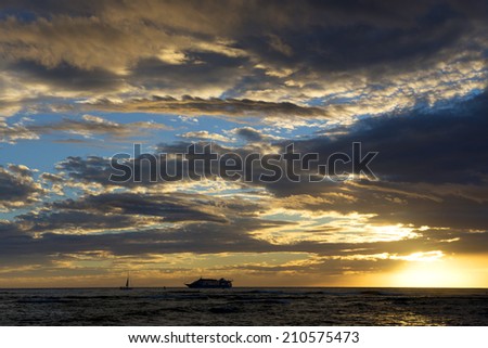 Hawaii sunset - gold sun reflection with cruise ship