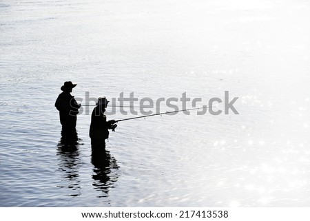 Fishing on the lake, two fishermen in the water