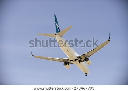 WESTJET AIRLINES - MAY 31, 2014: Boeing 737-800 with two jet engines is photographed before landing in Vancouver, YVR. The owner, Canadian compay WestJet Airlines was founded in 1996. British Columbia