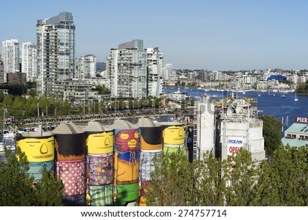 GRANVILLE ISLAND-MAY 2, 2015: Vancouver\'s oldest industry part Granville Island  changed in last years into famous shopping centre, except few companies. In the background is False Creek and Yaletown