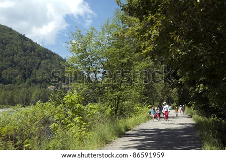 Children walking in the park with a teacher