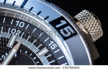 Detail of a luxury watch on black background. Selective focus, shallow depth of field.