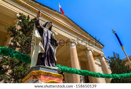 Nun statue in front of malta law courts in the republic street in Valletta.