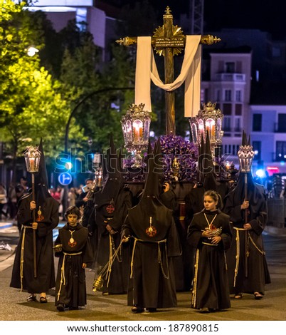 VALLADOLID, SPAIN -Â?Â? APRIL 17, 2014: Nazarenos carrying cross sculpture in the religious processions during Holy Week on Good Thursday Night, on April 17, 2014 in Valladolid, Spain.