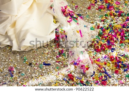 Floor full of rice, paper lace and confetti, after a wedding ceremony.