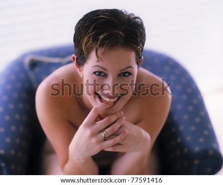 Stunning beautiful woman playfully bites her finger