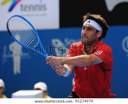 SYDNEY - JAN 13: Marcos Baghdatis hits a backhand in his match at the APIA Tennis International. Sydney - January 13, 2012