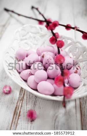 Pink Easter chocolate eggs in white bowl