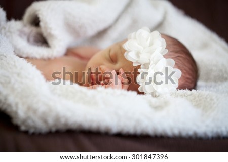 Newborn baby sleeping on white blanket