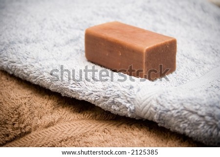 Light blue and brown towel with brown soap