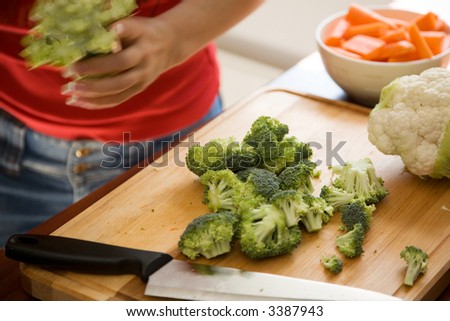 Young woman cooking healthy food with lots of vegetables