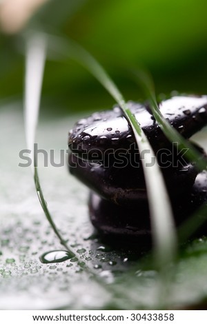 Black massage stones with water drops
