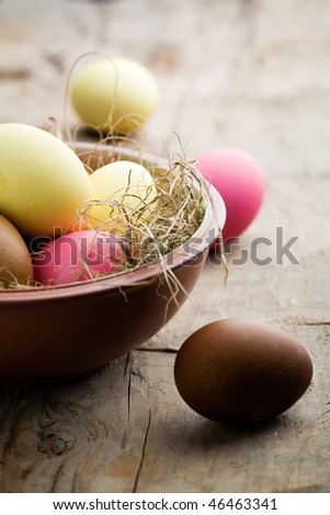 Easter eggs painted in yellow, pink and brown