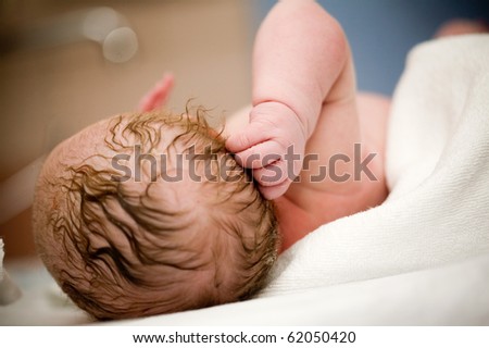 Newborn baby girl right after delivery, shallow focus