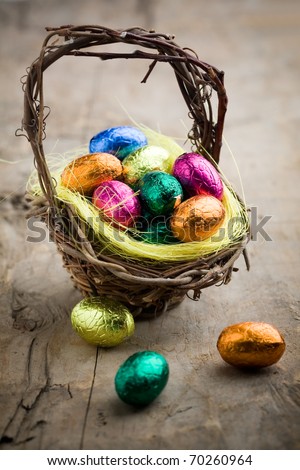 Colorful chocolate easter eggs in brown basket