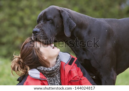 girl laughing while her dog kisses. tender moment,