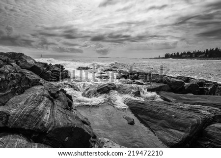 Rushing wave on Maine\'s rocky coastline taken in Bristol near Pemaquid lighthouse.