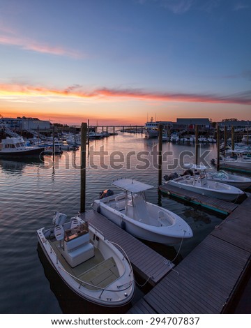 Barnstable Harbor Marina Area at Sunset showing fishing and whale watch boats.