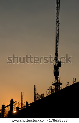 construction site silhouetted at sunset