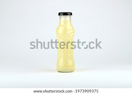 Image, Stock Photo Lemonade in bottle with drinking straw and ingredients: strawberry and lime slice at white background.
