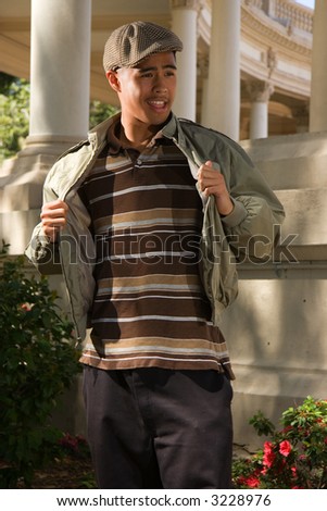 Ethnic mix teen male standing outside smiling
