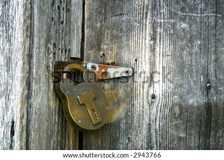 old fashioned solid brass lock on log cabin door