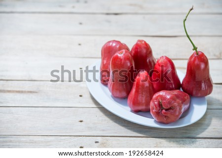 Seven Rose apples on wooden table