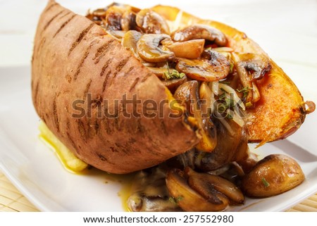 Oven cooked sweet potato , filled with mushroom sauce and roasted mushrooms , low angle view