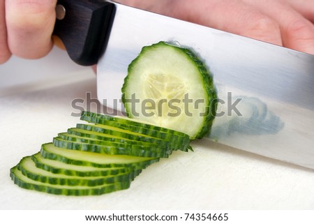 Cutting cucumber to slices with chef knife