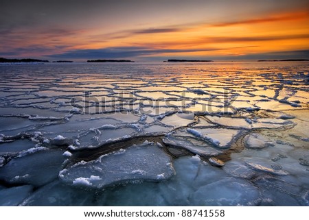 Early morning winter landscape with sunrise and ice floats, in the sea coast of Helsinki, Finland