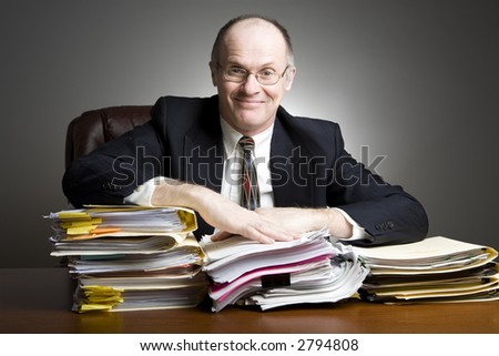 Series of an older businessman at desk.