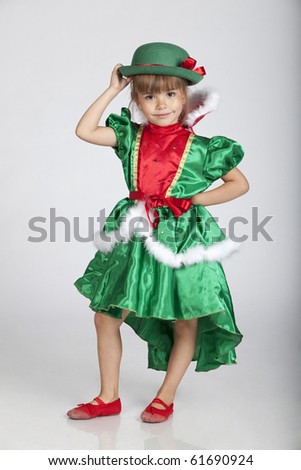 Full length portrait of an adorable little girl wearing green outfit and hat for Saint Patrick\'s Day, studio image