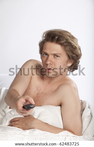 Attractive young man watching adult movies on tv. Studio shot. See more in my portfolio