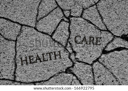 Health Care on cracked cement symbolizing a broken system