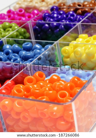 Closeup of beads in bins separated for making crafts jewelry