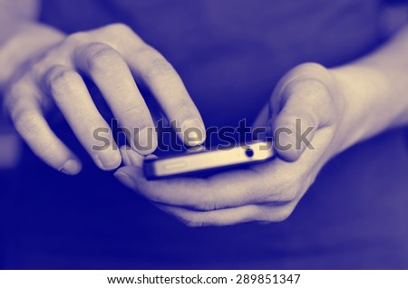 Person holding smart phone in hands to communicate and text