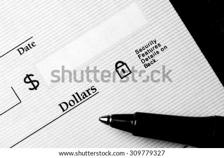 Pen on blank check to be written with dollars