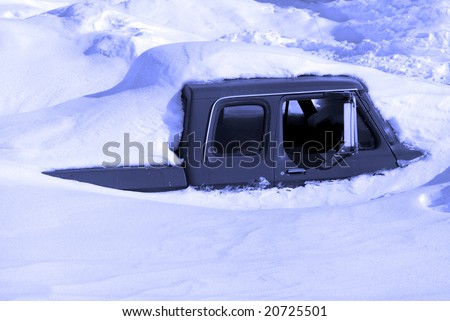 Snowy winter road with truck parked in snow drift buried in snow