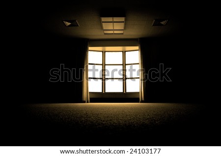 Large dark room with bright light coming in through paned window