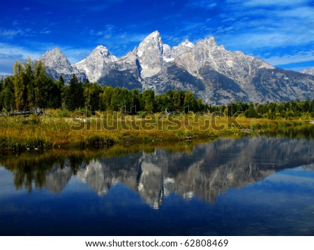 Detail of Grand Tetons Mountains with blue sky with relfection in river